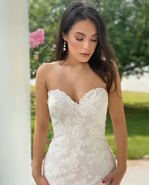Bride in a strapless lace gown outdoors, radiant soft glam makeup